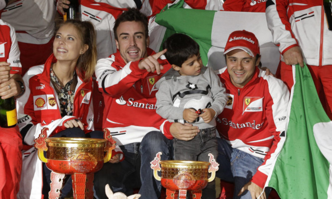 Fernando Alonso, centre, and his teammate Felipe Massa celebrate after Alonsos win in Shanghai.