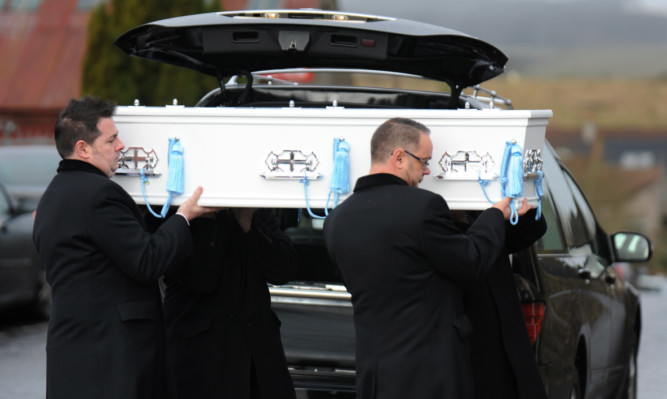 Logan's coffin gets carried into Leslie Baptist Church.