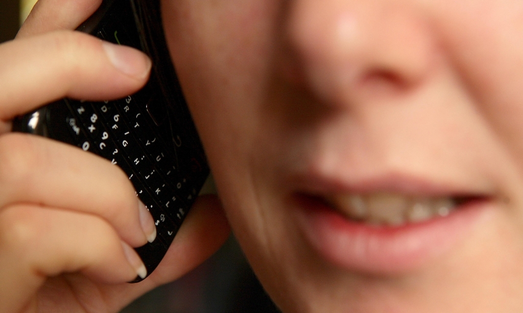 PICTURE POSED MY MODEL File photo dated 15/03/2011 of a close-up view of a woman talking on a mobile phone as unwanted calls and automated recordings from PPI claim companies are Britons' top annoyance, with the average person receiving six of them a week, a survey has found.