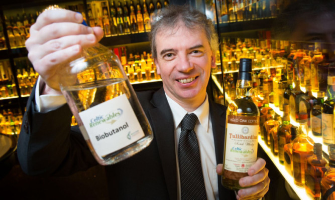 Martin Tangney with bio-butanol, made from the by-products of whisky fermentation.
