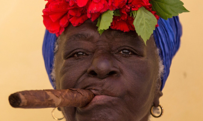 The Scottish team could soon by smoking cigars like this woman in Havan, Cuba. (Photo by Aykut Unlupinar/Anadolu Agency/Getty Images)