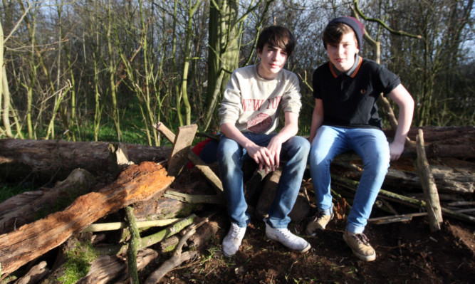 Ross Dougan and Bobby Robertson in the remains of the den.