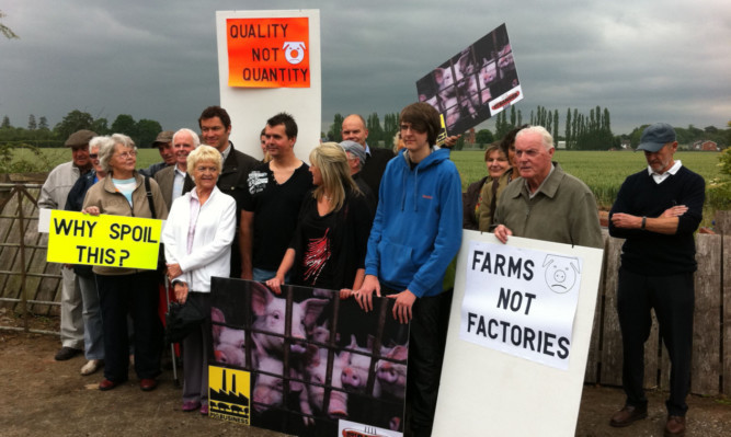 Actor Dominic West, behind woman in white jacket, with some of the people who protested against the proposal.