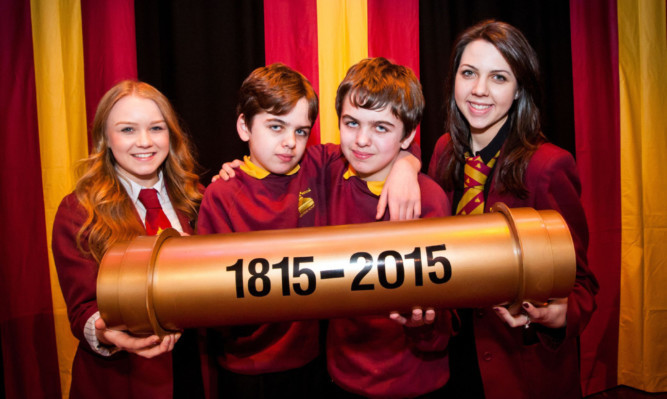 Pupils Rachel Dunn, Adam and Ryan Strachan and Gemma Everett with the time capsule.