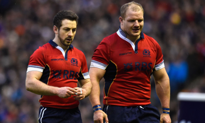 Skipper Greig Laidlaw and prop Euan Murray dejectedly leave the Murrayfield pitch after defeat to Italy.