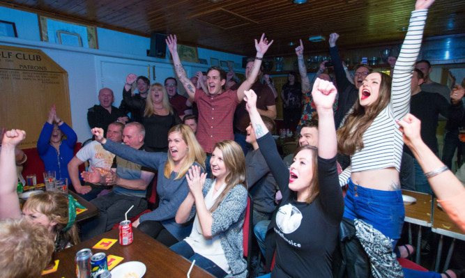 Stevie McCrorie (centre) and his close friends and family celebrate in Alva after seeing him win through to the next stage.