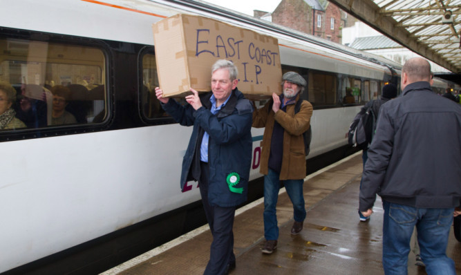 Protestors at Arbroath Station with a 'coffin'.