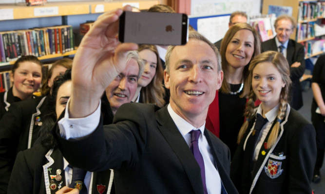 Jim Murphy takes a selfie as he visits Kirkland High School in Leven with general election candidate Melanie Ward and Iain Gray.