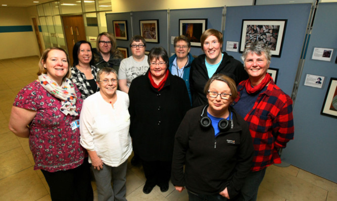 Members of Cameraderie, the lesbian, bisexual and transgender photographic group, at their exhibition with Celeste Robinson, front left, from D&A College, who helped organise the event.