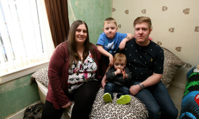 Michelle Middleton and partner John-Paul Jaffrey with their children Luke and Cole in their flat.