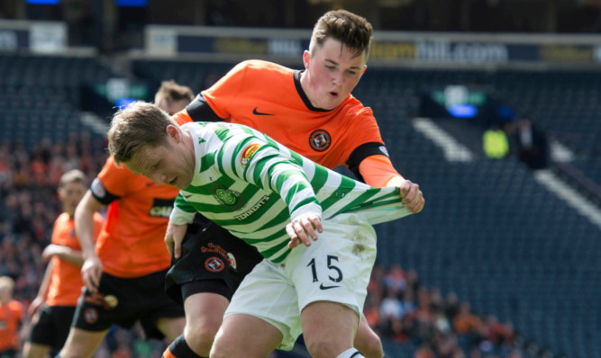 Dundee Uniteds John Souttar gets to grips with Celtic star Kris Commons at Hampden.