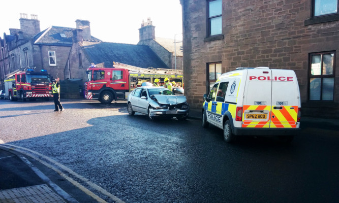 Fire fighters and police at the scene of the accident on the junction of John Street and Market Street.