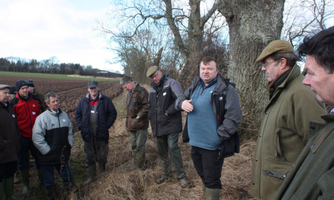 A group of farmers listening to Alan Elder explaining the practicalities of greening.