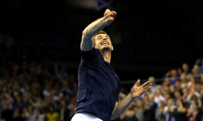 Andy Murray of The Aegcelebrates victory in his singles match against John Isner.