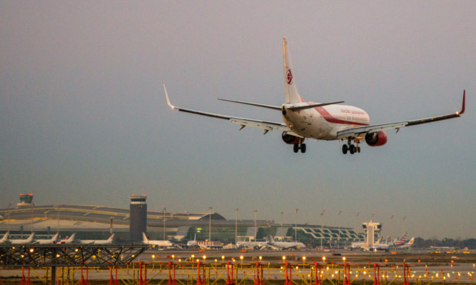 BARCELONA, SPAIN - FEBRUARY 11:  A plane operated by Air Algerie lands at Aena operated Barcelona - El Prat International Airport on February 11, 2015 in Barcelona, Spain. Shares in state-controlled Spanish airports operator, Aena, began trading today on the Madrid stock market. The Spanish government will retain a 51% controlling share in the firm, as it seeks to raise 3.9 billion Euros through the sale of the remaining 49%. Aena operates major hubs in Barcelona and Madrid, as well as a further 15 airports in Europe and America, including London Luton.  (Photo by David Ramos/Getty Images)