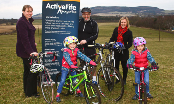 Cllr Mark Hood looks forward to using the closed loop circuit with his daughters, Lily and Daisy. Also pictured are cycling development officer Kirsteen Torrance (left) and Sarah Roxburgh, head of community use schools in the area.