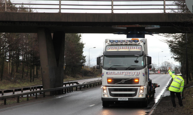 The lorry became trapped under a flyover on the west-bound carriageway on Monday afternoon.