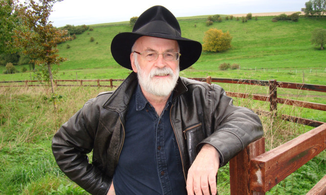 Undated handout photo issued by Penguin Random House of Sir Terry Pratchett who has died at the age of 66. PRESS ASSOCIATION Photo. Issue date: Thursday March 12, 2015. See PA story DEATH Pratchett. Photo credit should read: Rob Wilkins/PA Wire

NOTE TO EDITORS: This handout photo may only be used in for editorial reporting purposes for the contemporaneous illustration of events, things or the people in the image or facts mentioned in the caption. Reuse of the picture may require further permission from the copyright holder.