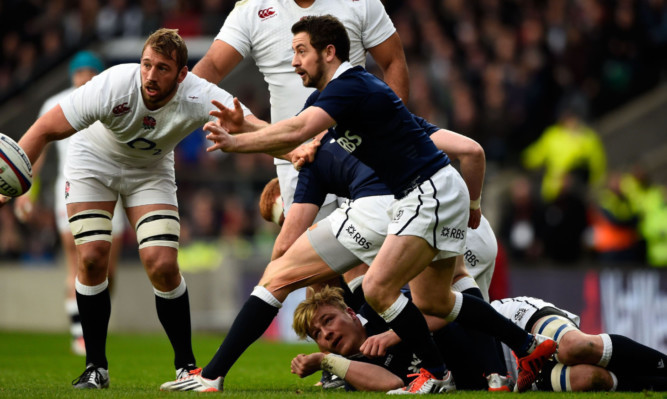 Greig Laidlaw drives Scotland forward at Twickenham.