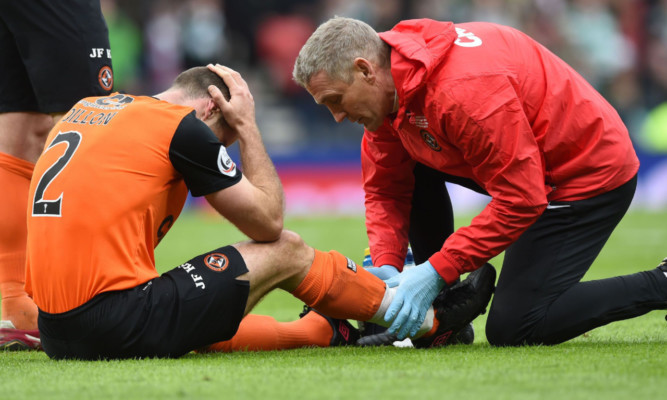 Sean Dillon receiving treatment after clash with Virgil van Dijk.