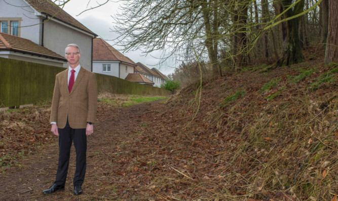 Mr Wincott in one of the woodland areas residents say needs more attention.