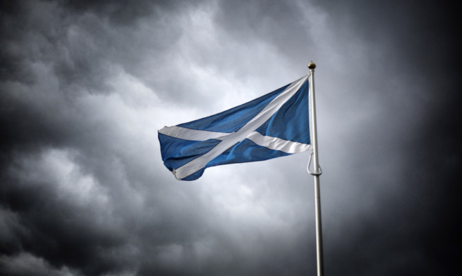 CARTER BAR, SCOTLAND - SEPTEMBER 14: (EDITORS NOTE: Image has been processed with digital filters) A Scottish Saltire flag flies on the border with England on September 14, 2014 in Carter Bar, Scotland. The latest polls in Scotland's independence referendum put the No campaign back in the lead, the first time they have gained ground on the Yes campaign since the start of August.  (Photo by Peter Macdiarmid/Getty Images)