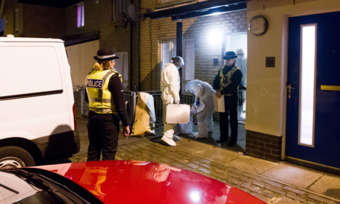 Police and forensics officers at the scene in Gleneagles Street. Picture: Steve MacDougall.