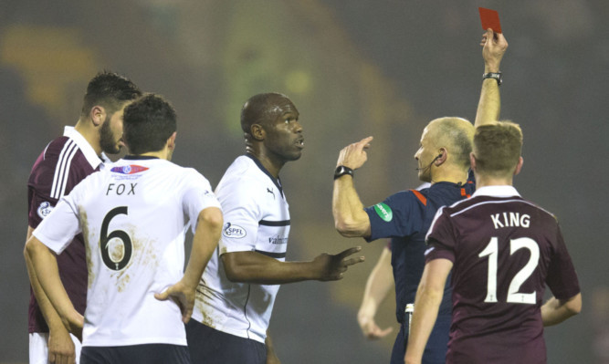 Referee George Salmond shows Christain Nade a red card after his challenge on Hearts' Kevin McHattie.