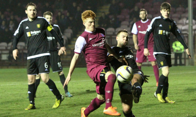 Lichties striker Simon Murray in the thick of the action as Arbroath press.