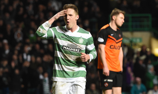 United defender Calum Morris knows the tie is over as Kris Commons celebrates after giving Celtic a 3-0 lead.