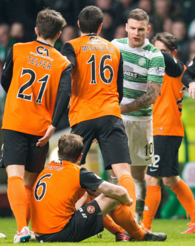 Paul Paton sits on the turf as his team-mates confront Anthony Stokes.