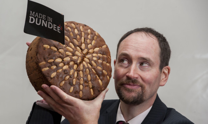 Baker Martin Goodfellow with a Dundee cake, which has yet to get protected geographical indication status.