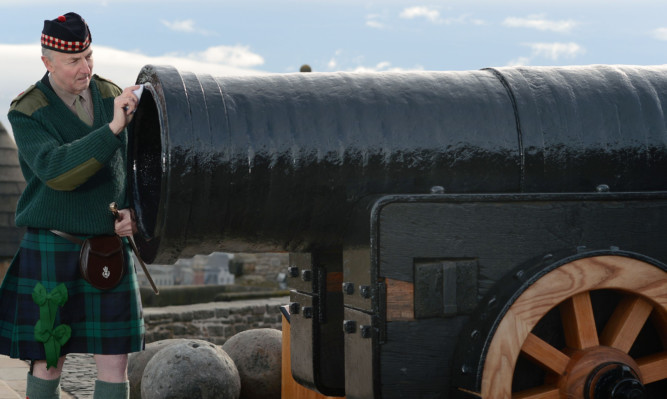 Major Niall Archibald of the Royal Regiment of Scotland inspects the restored cannon.