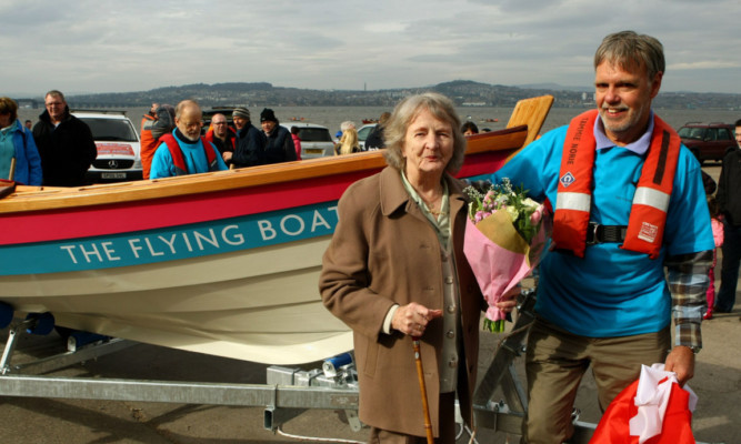 Beside the boat is Nina Webster  who named the boat and whose brother Ian Davidson was in the Canadian Air Force  and Ralph Webster.