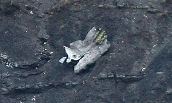 Debris of the crashed Germanwings passenger jet is scattered on the mountainside near Seyne les Alpes.