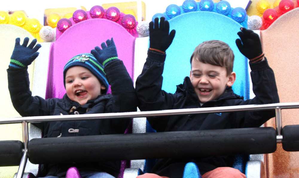 Lewis and Kieran MacDonald having fun at the Links Market despite the wet weather.