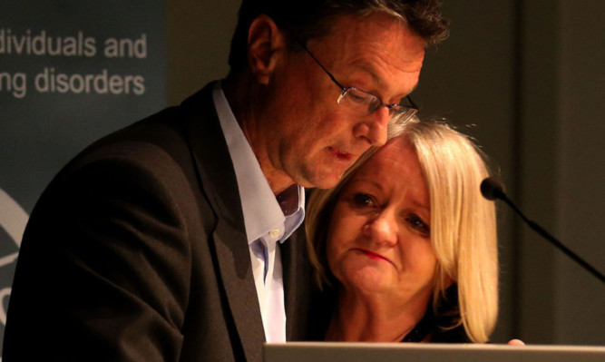Bill Wright from Haemophilia Scotland comforts Lorna Rusling, from Aberdeen, who lost her husband, at the publication of the report.