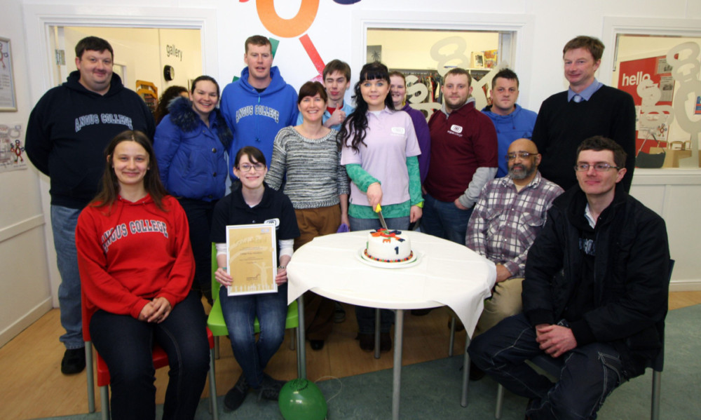 Katie Anderson, centre left, with Angus College shop volunteers around the birthday cake, which was cut by Inesa Kononovica.