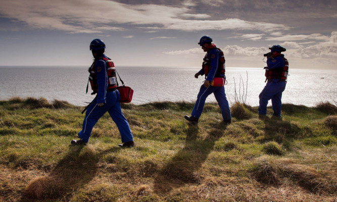 Search teams at the cliffs on Friday.
