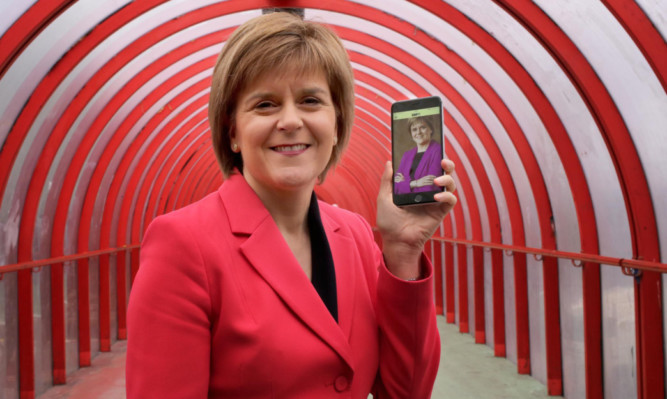 Nicola Sturgeon promoting a new SNP mobile app ahead of this weekend's conference in Glasgow.