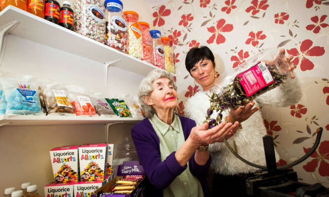 Ann Cosgrove and Debbie Douglas prepare the shop for more customers.