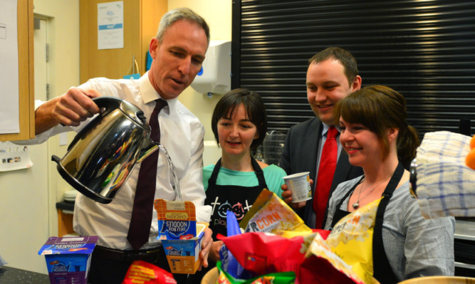 Scottish Labour leader Jim Murphy prepares a kettle box food parcel, which are given to people who dont have access to cooking facilities.