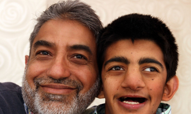 Sandy Sarwar with 20-year-old Tubarik Hussain, whose parents have been refused entry to the UK.