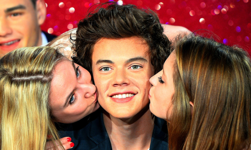 Jodie Wells and Ruby Yeomans (right) both 16 and from Essex, pucker up with the wax Harry Styles.