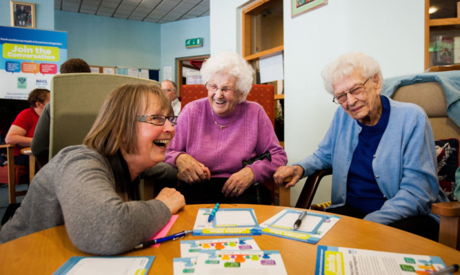 Sarah Renwick from Positive Choice chats with May Murray and Margaret Adamson.