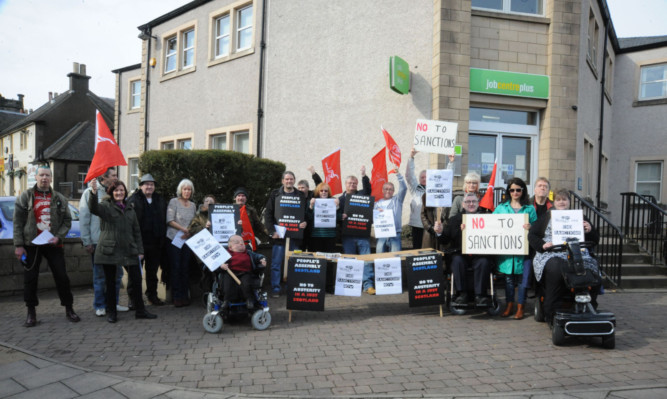 Members of the Peoples Assembly Fife and Unite union protest against sanctions outside Kirkcaldy Jobcentre last month.