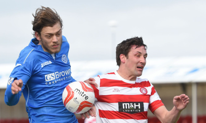 Murray Davidson goes up for a header with Martin Canning.