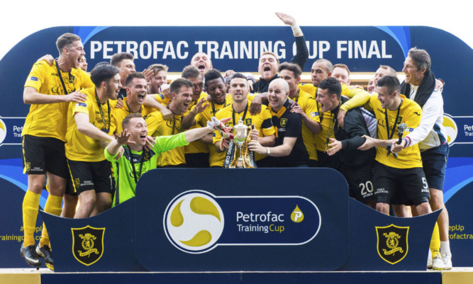 The Livingston players celebrate after winning the Petrofac Training Cup.