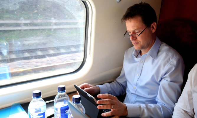 Liberal Democrat leader Nick Clegg works while traveling on a train.