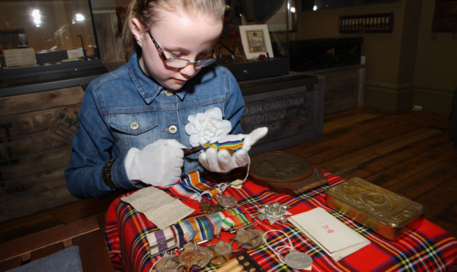 Lucy Cammock looks at medals at the Black Watch Museum.